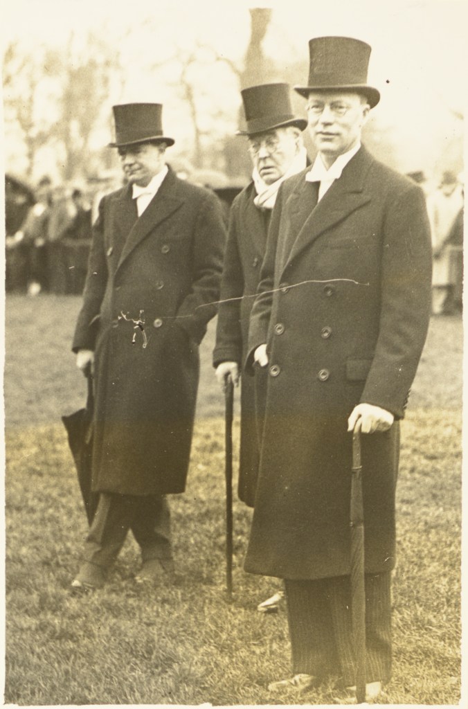 Photograph of M. R. James (centre) taken on St. Andrew's Day, 1934, watching the wall game in progress. On the left is John Comyn Vaughan Wilkes, Master in College 1930-1937, and subsequently Warden of Radley College, Oxfordshire; and on the right Sir Claude Aurelius Elliot, Head Master of Eton 1933-1949, and provost 1949-1965. Reproduced with kind permission of The Provost and Fellows of Eton College.
